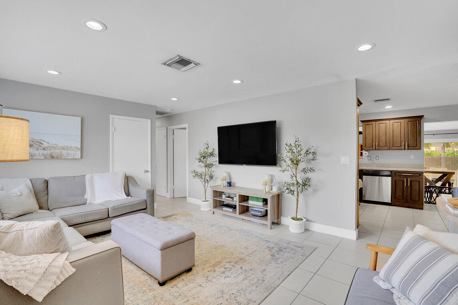 313 Davis Road Palm Springs, FL 33461 - Photo 1 of 39 a living room with furniture and a flat screen tv