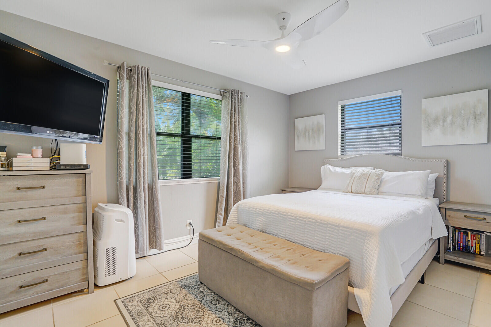 313 Davis Road Palm Springs, FL 33461 - Photo 20 of 39 a bedroom with a large bed and a flat screen tv