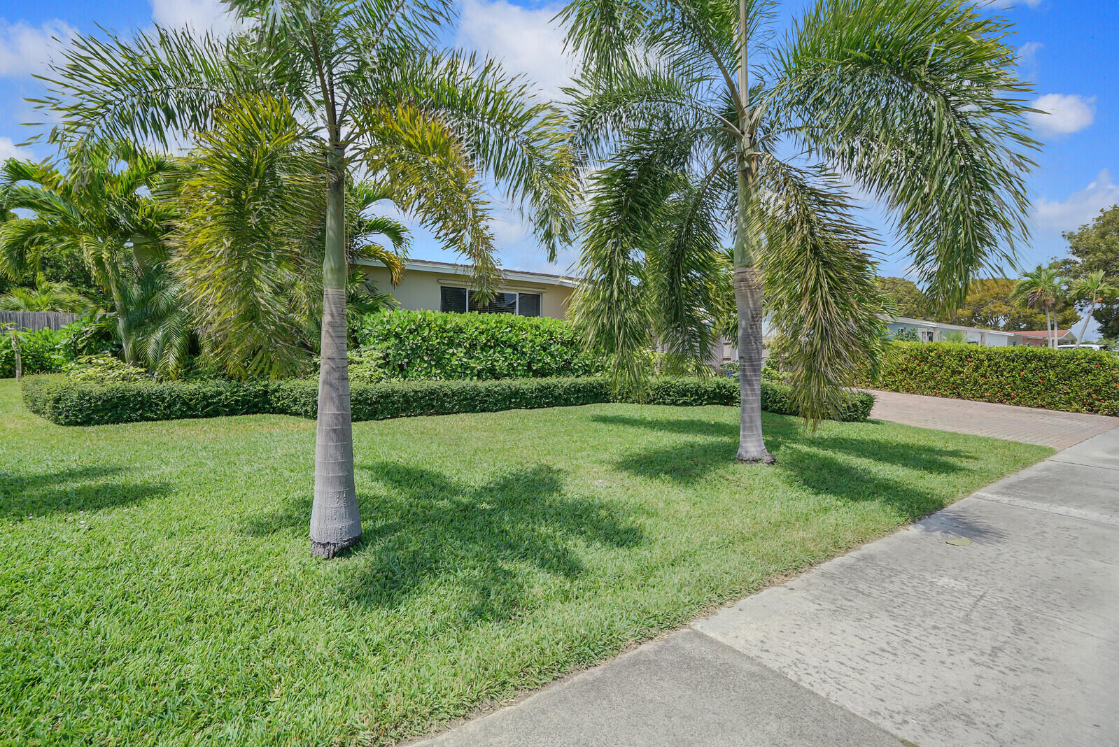 313 Davis Road Palm Springs, FL 33461 - Photo 2 of 39 a view of a house with a yard