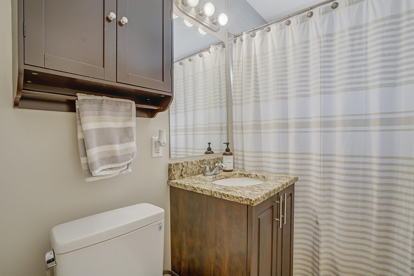 313 Davis Road Palm Springs, FL 33461 - Photo 23 of 39 a bathroom with a sink a toilet and shower curtain