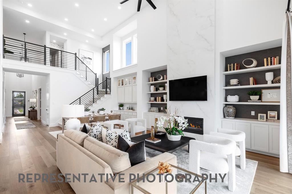4415 Azalea Trail Oak Point, TX 75068 - Photo 3 of 38 a living room with fireplace furniture and a flat screen tv