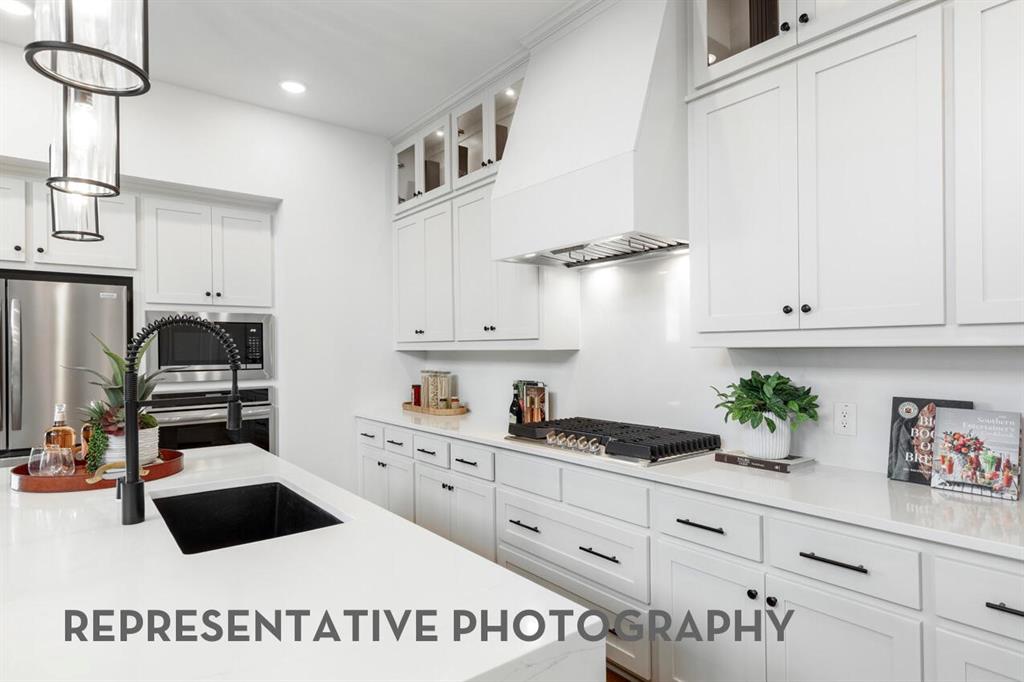 4415 Azalea Trail Oak Point, TX 75068 - Photo 5 of 38 a kitchen with white cabinets a sink and dishwasher