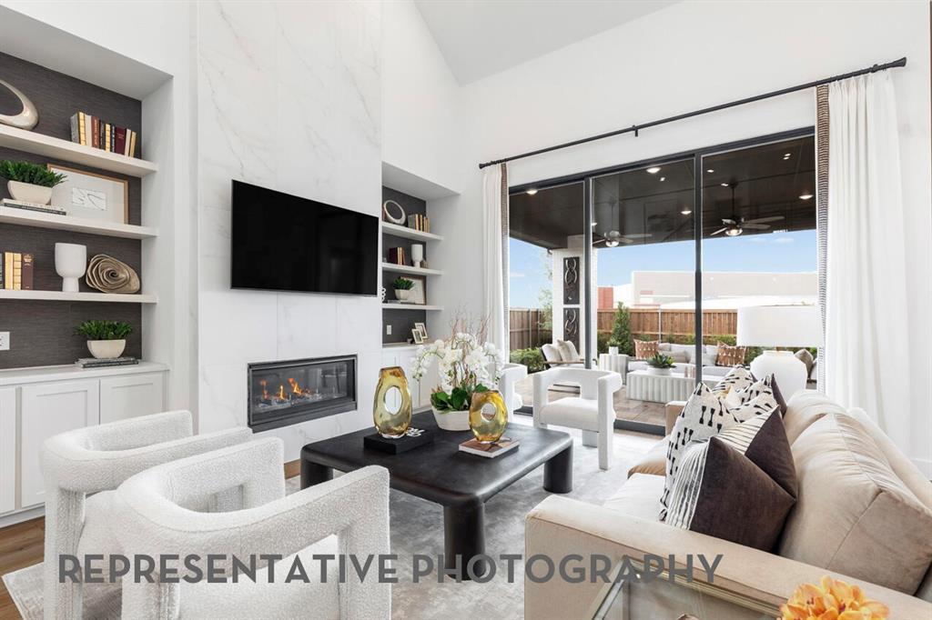 4415 Azalea Trail Oak Point, TX 75068 - Photo 8 of 38 a living room with furniture a fireplace and a flat screen tv