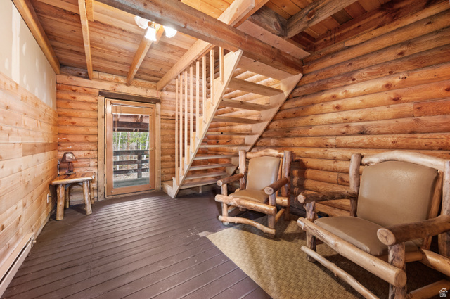 4725 Pine Ridge Road Evanston, UT 82930 - Photo 42 of 82 Interior space featuring log wall construction and wood-finish flooring