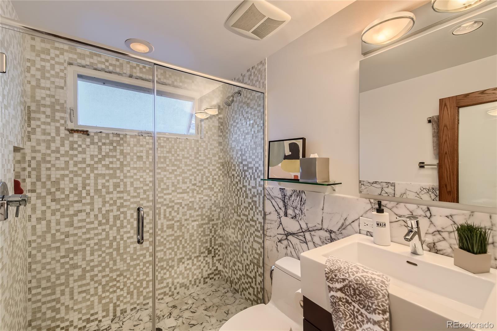 161 3rd Avenue Niwot, CO 80544 - Photo 17 of 41 a bathroom with a granite countertop sink a toilet and shower