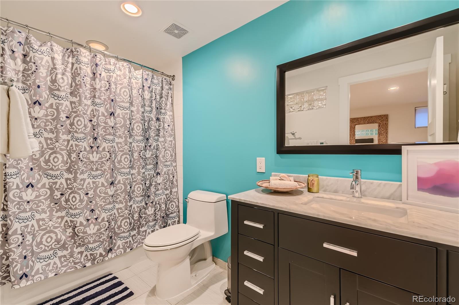 161 3rd Avenue Niwot, CO 80544 - Photo 26 of 41 a bathroom with a granite countertop sink toilet mirror and shower