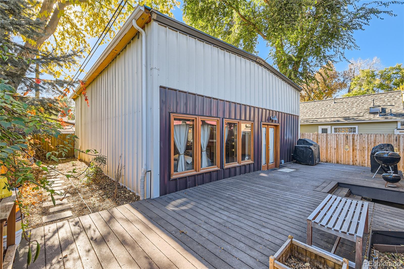 161 3rd Avenue Niwot, CO 80544 - Photo 30 of 41 a view of a house with wooden deck and furniture