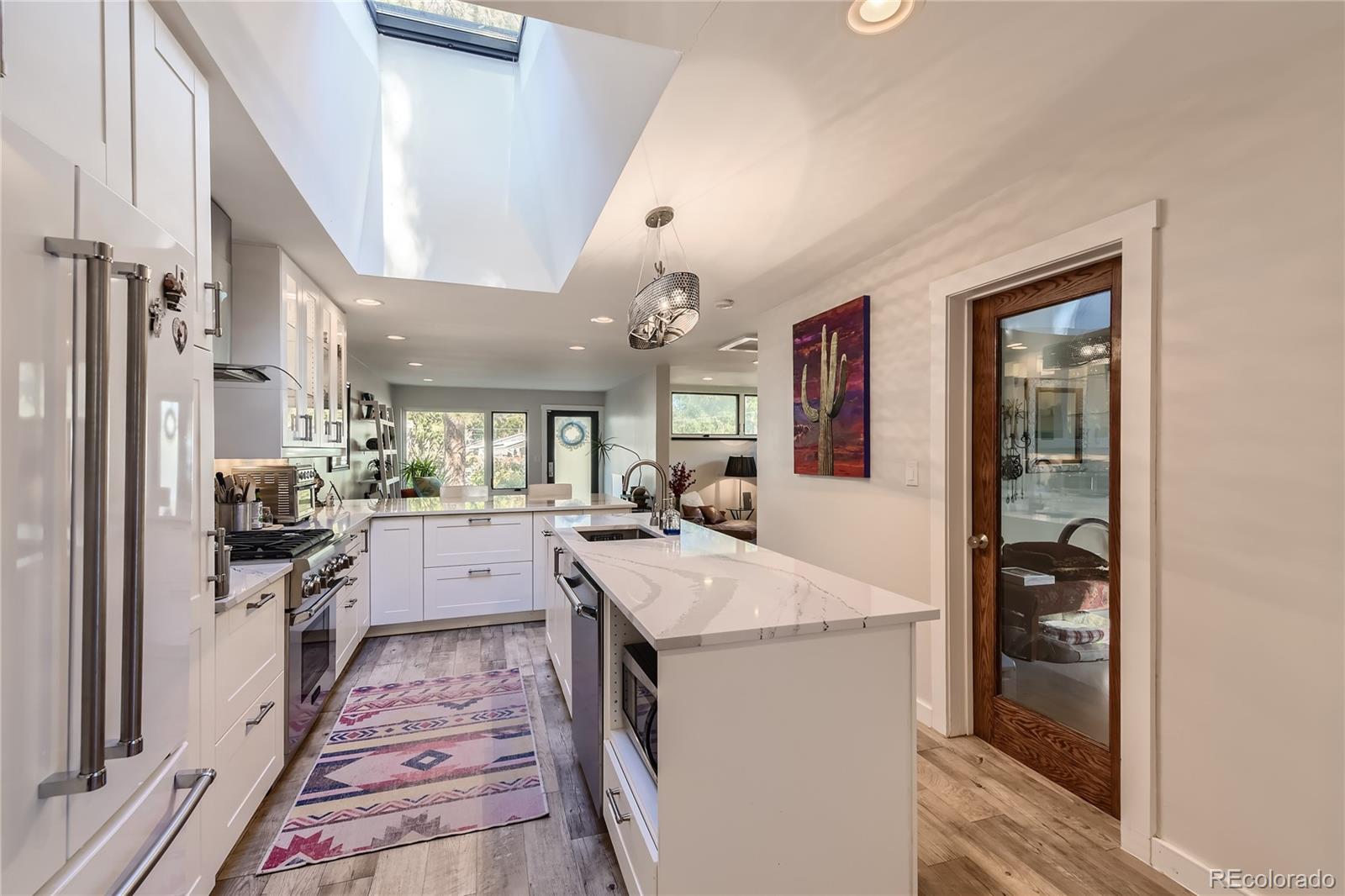161 3rd Avenue Niwot, CO 80544 - Photo 10 of 41 a large kitchen with a lot of counter space and wooden floor