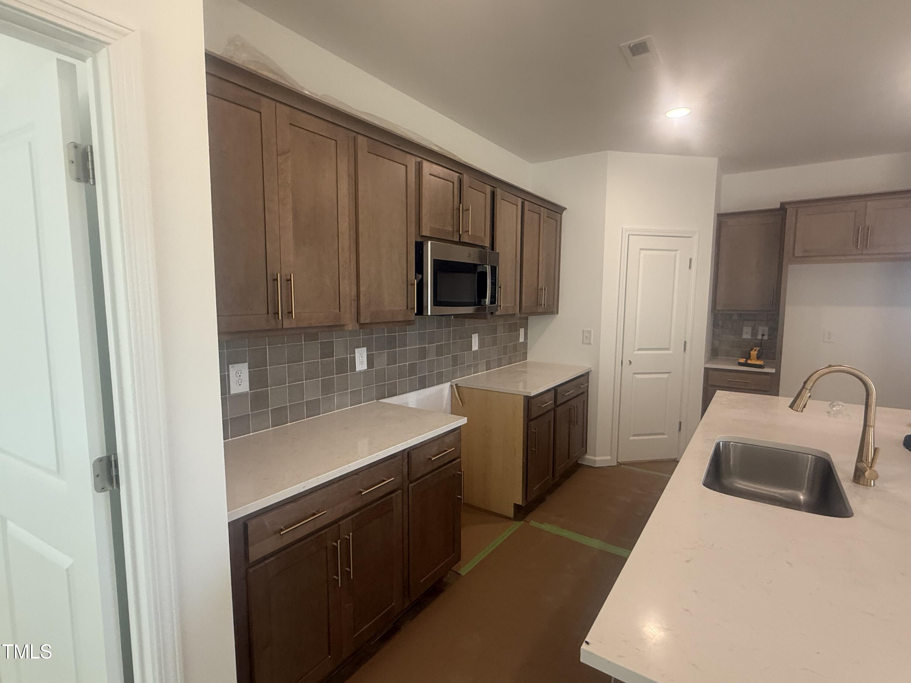 11751 Salers Loop Middlesex, NC 27557 - Photo 2 of 30 a kitchen with a sink cabinets and stainless steel appliances