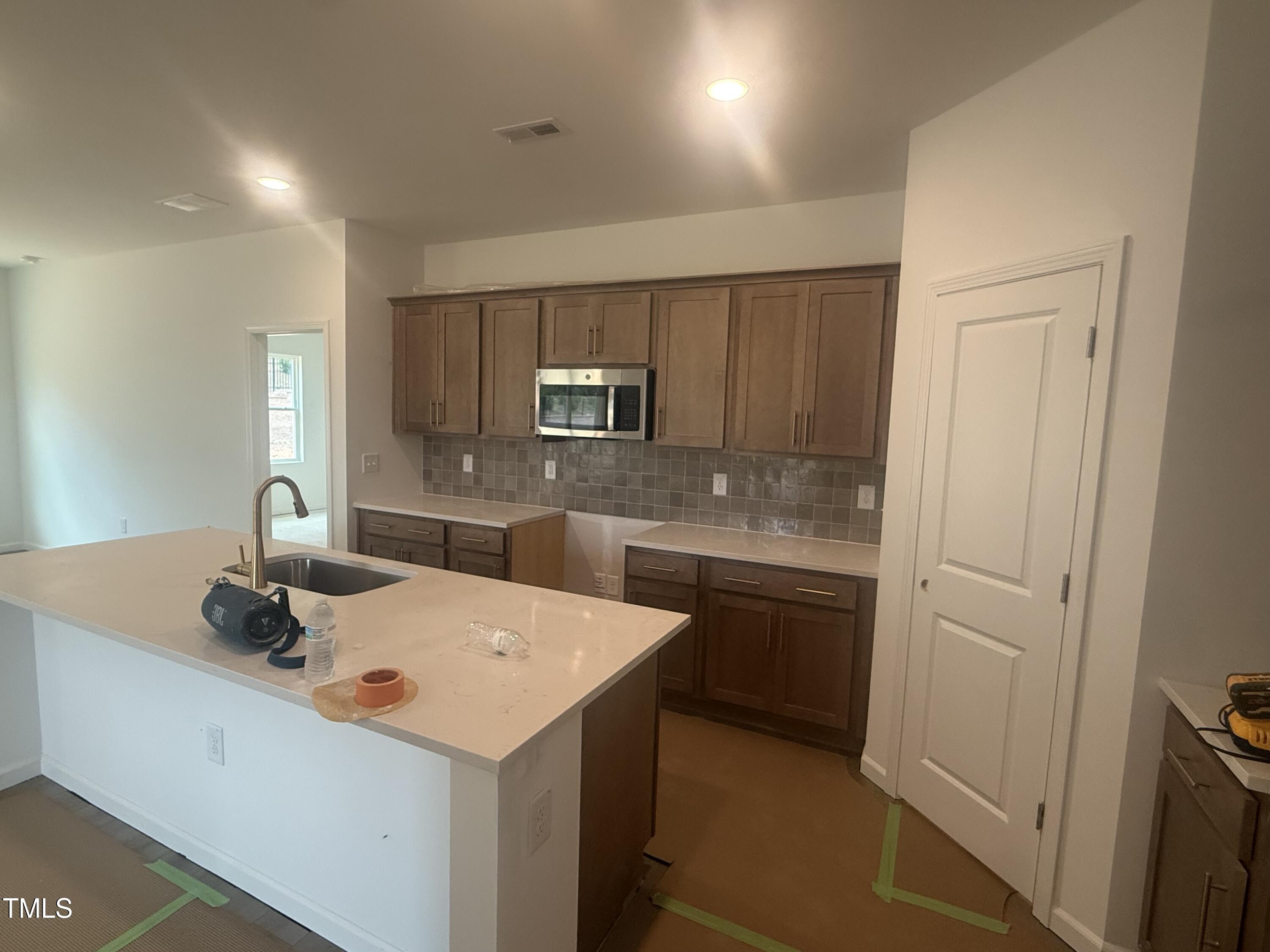 11751 Salers Loop Middlesex, NC 27557 - Photo 23 of 30 a kitchen that has a sink and a stove in it