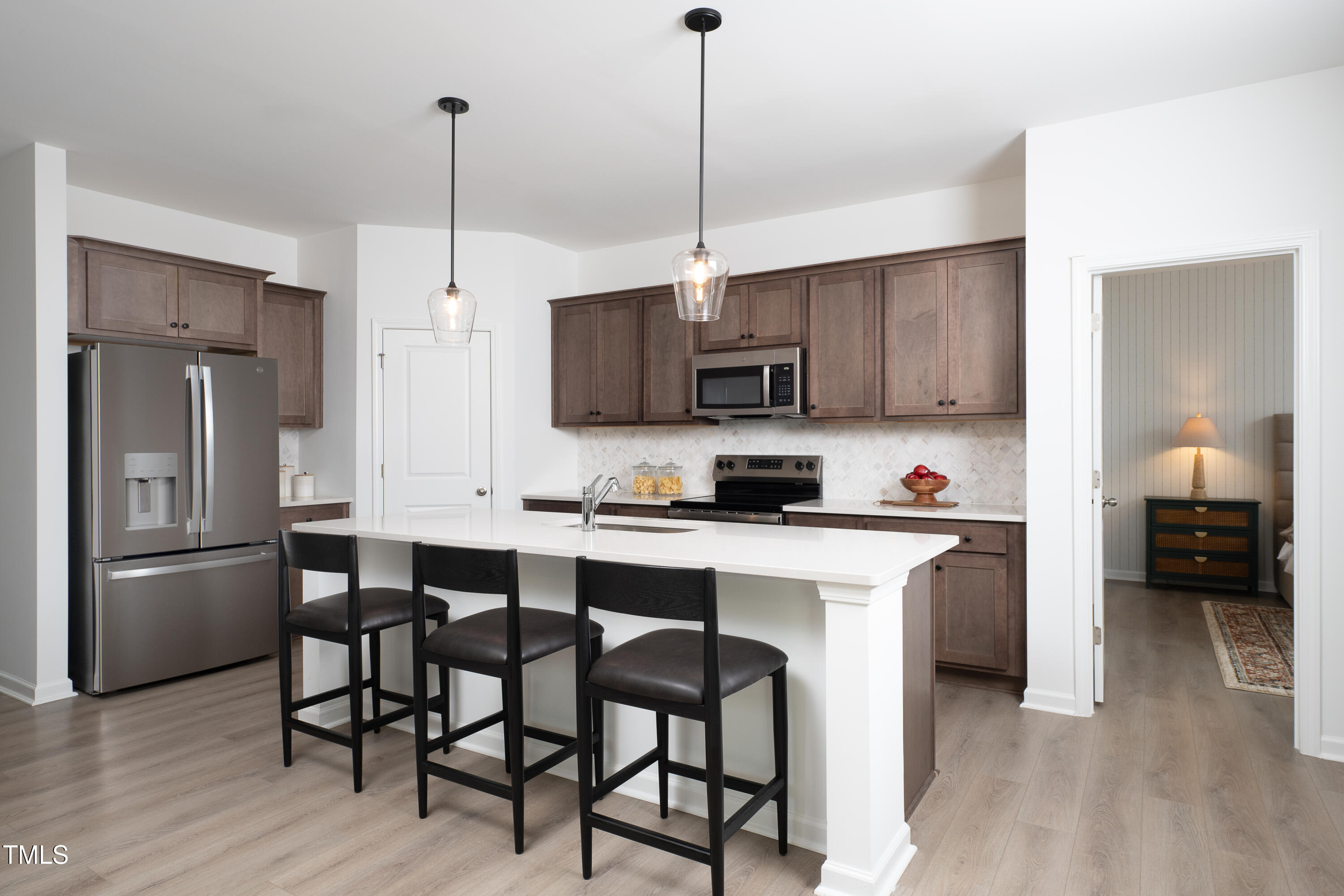 11751 Salers Loop Middlesex, NC 27557 - Photo 5 of 30 a kitchen with stainless steel appliances a stove a sink refrigerator and microwave