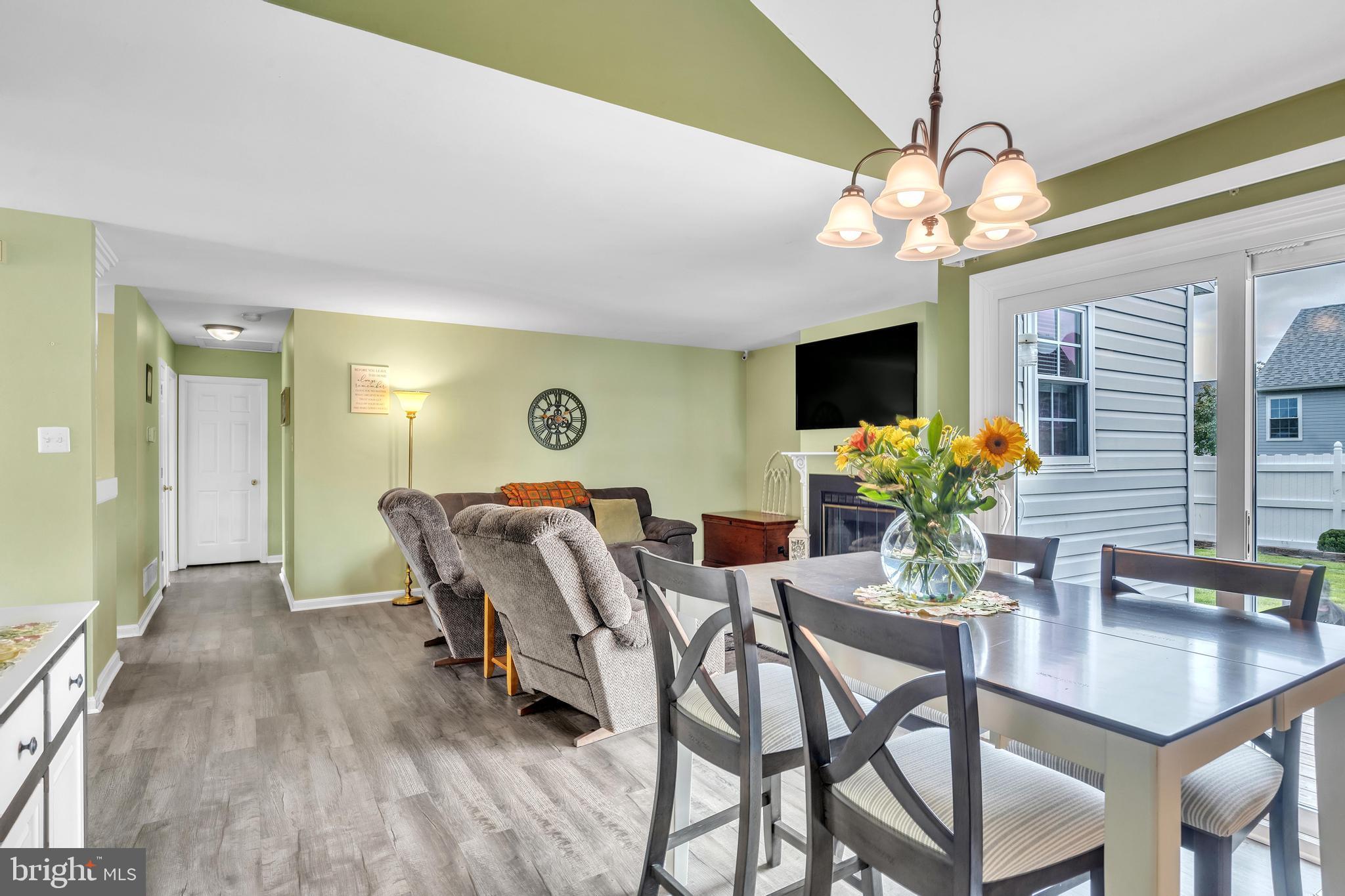 5 Patricia Circle Bear, DE 19701 - Photo 5 of 23 a dining room with furniture potted plants and wooden floor