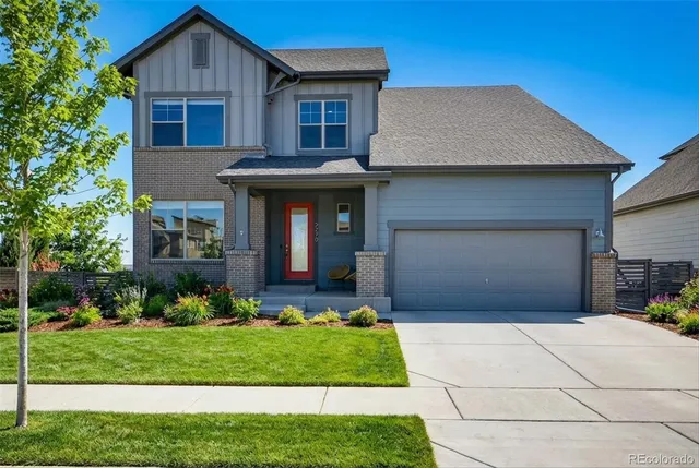 a balcony with wooden floor table and chairs
