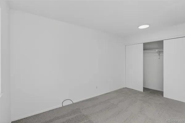 a view of a livingroom with a ceiling fan and window