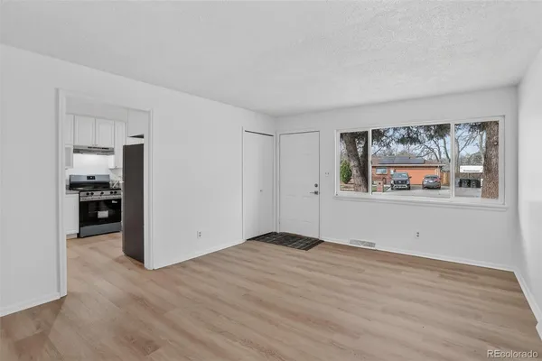 a view of an empty room with wooden floor