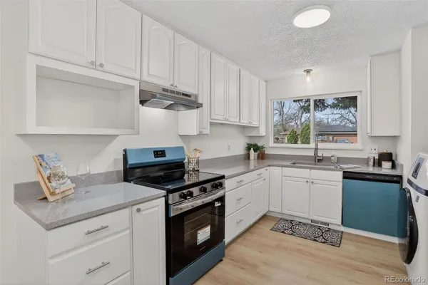 a kitchen with a sink cabinets and window