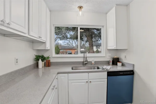 a kitchen with white cabinets and a stove with white wooden cabinets