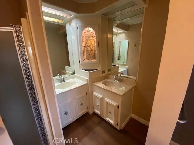 a bathroom with a double vanity sink and a mirror