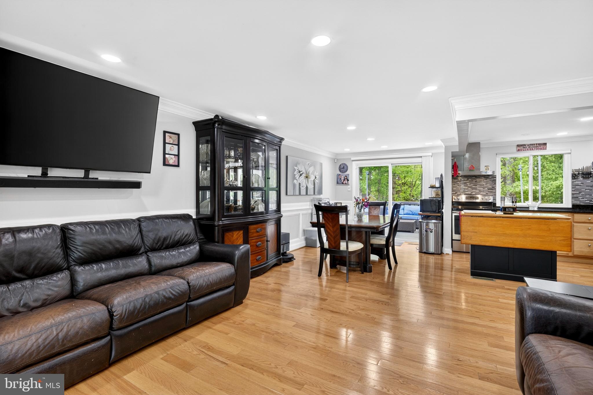 8373 Magic Leaf Road Springfield, VA 22153 - Photo 19 of 69 a living room with furniture and a flat screen tv