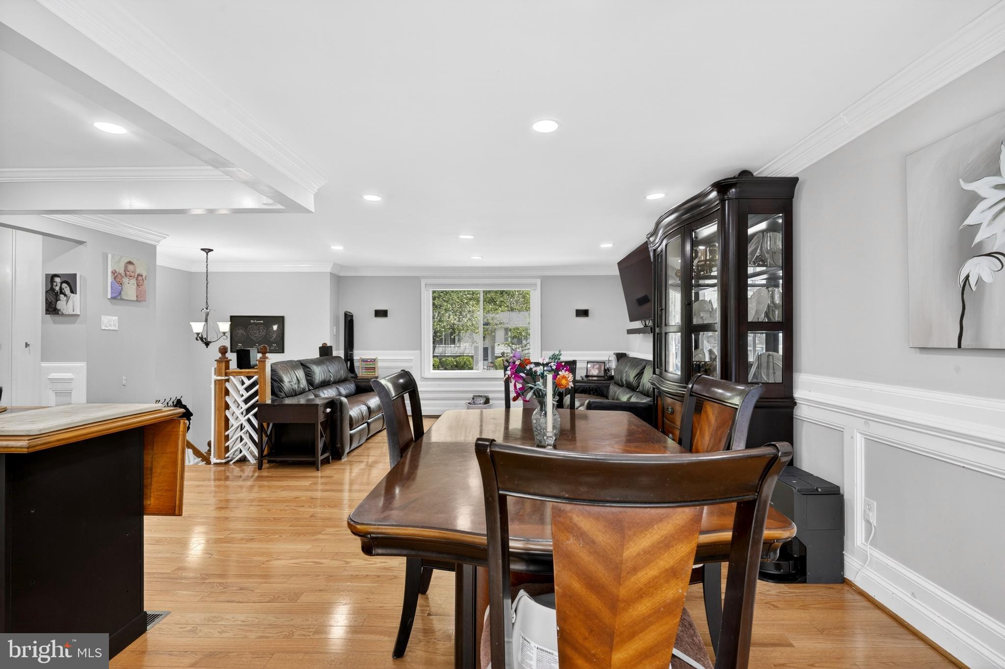 8373 Magic Leaf Road Springfield, VA 22153 - Photo 21 of 69 a view of a dining room with furniture and wooden floor
