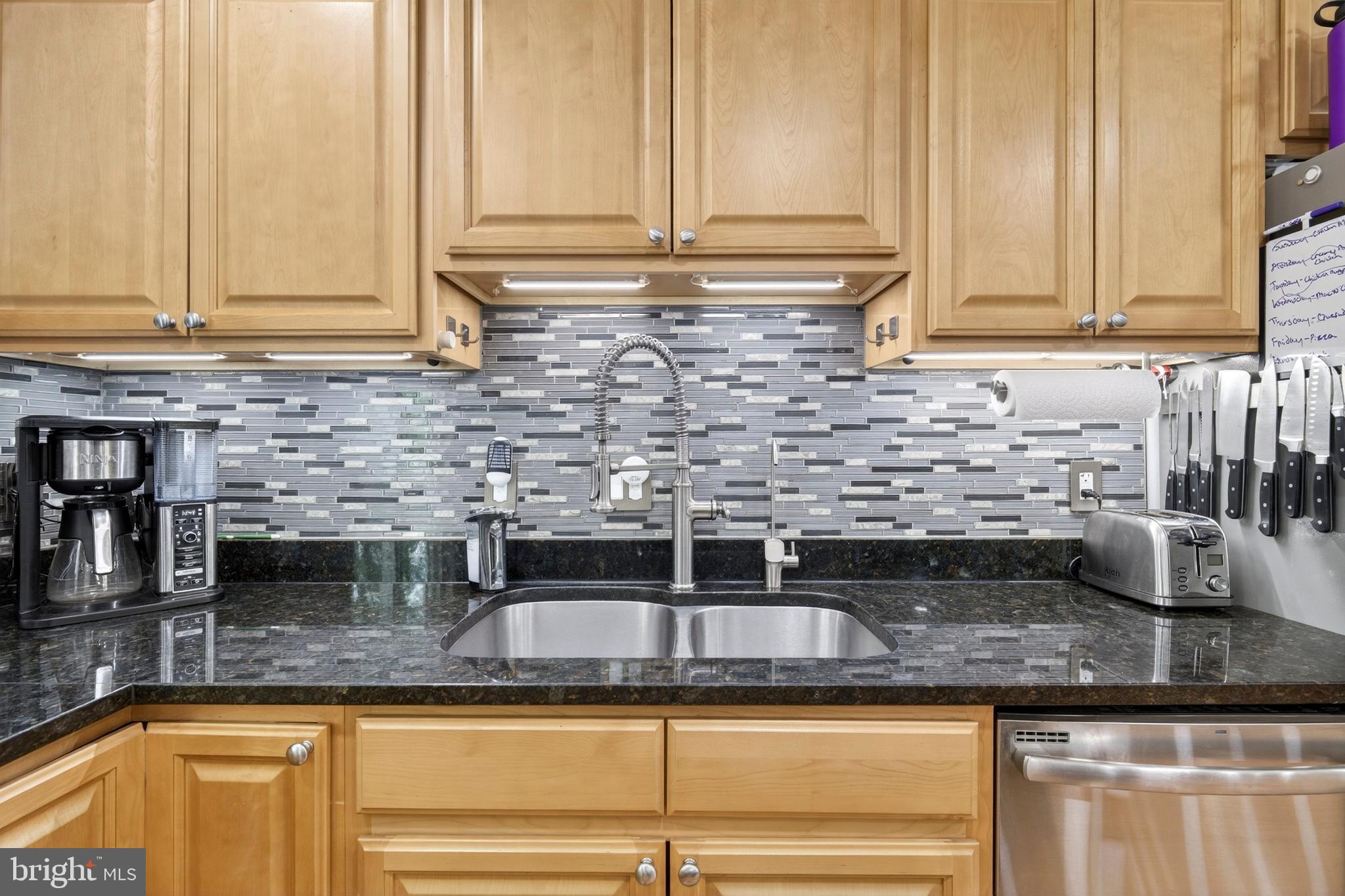 8373 Magic Leaf Road Springfield, VA 22153 - Photo 25 of 69 a kitchen with granite countertop a sink and cabinets