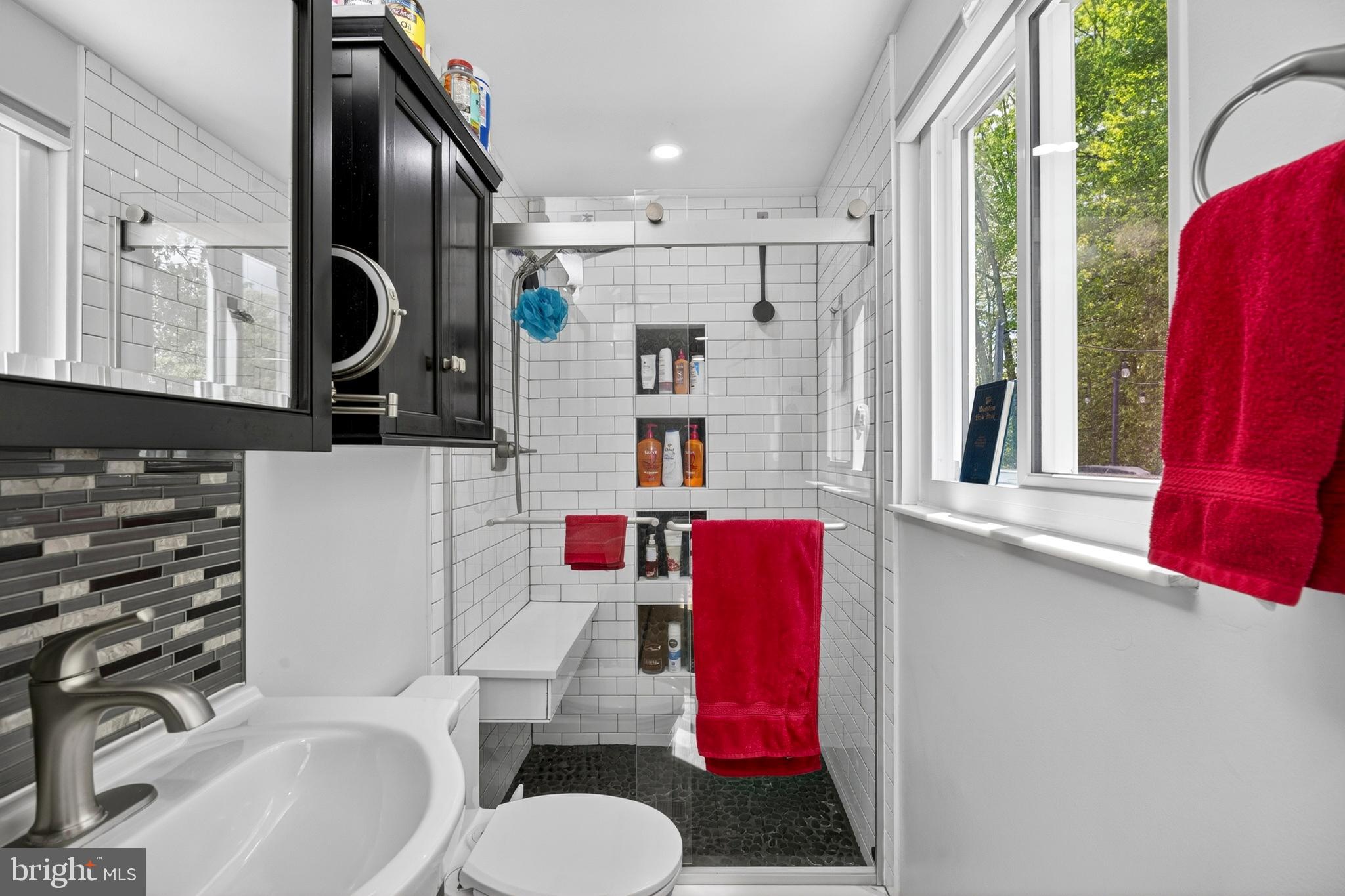 8373 Magic Leaf Road Springfield, VA 22153 - Photo 34 of 69 a bathroom with a sink toilet mirror and vanity
