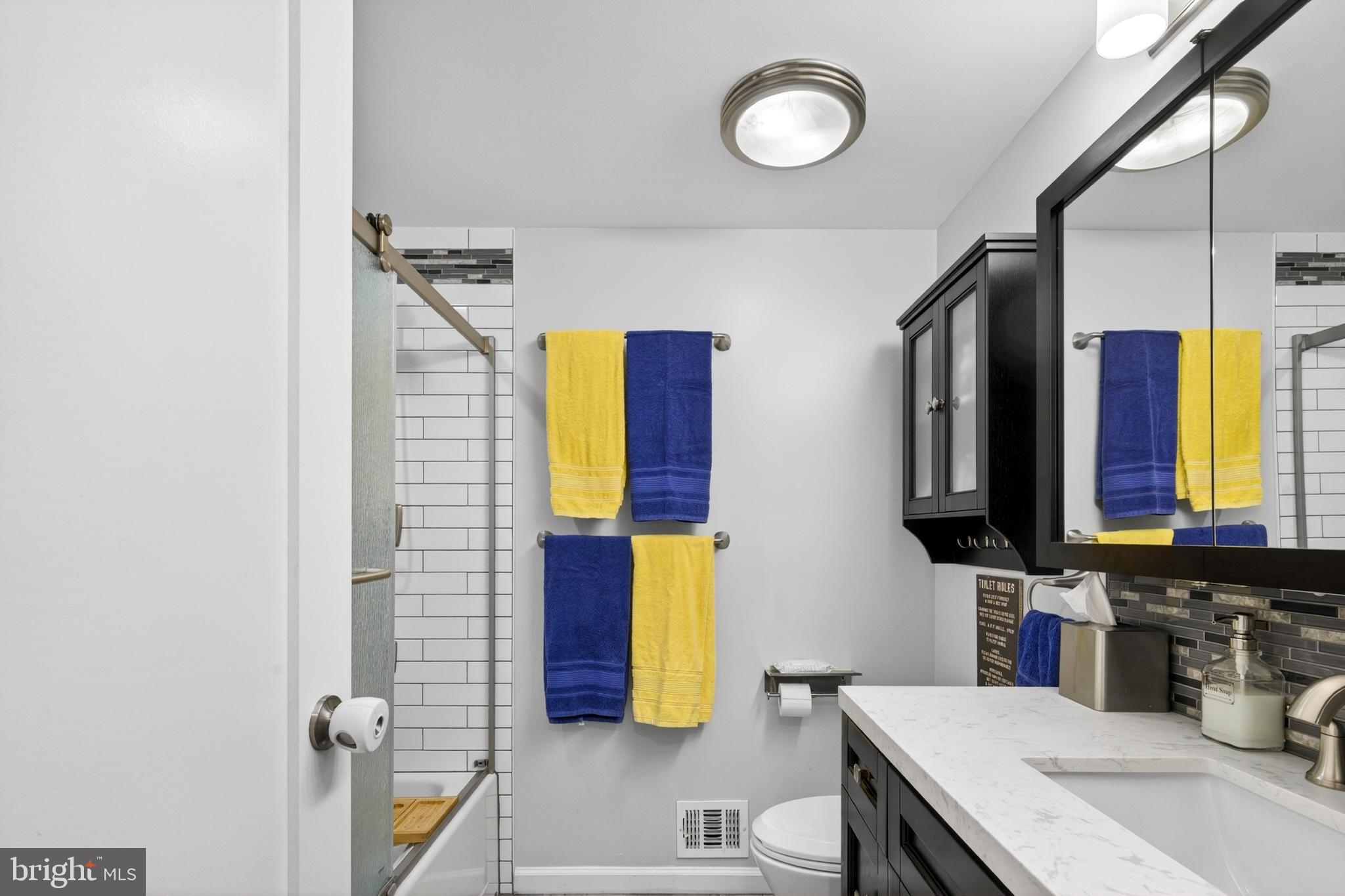 8373 Magic Leaf Road Springfield, VA 22153 - Photo 39 of 69 a bathroom with a sink and a mirror