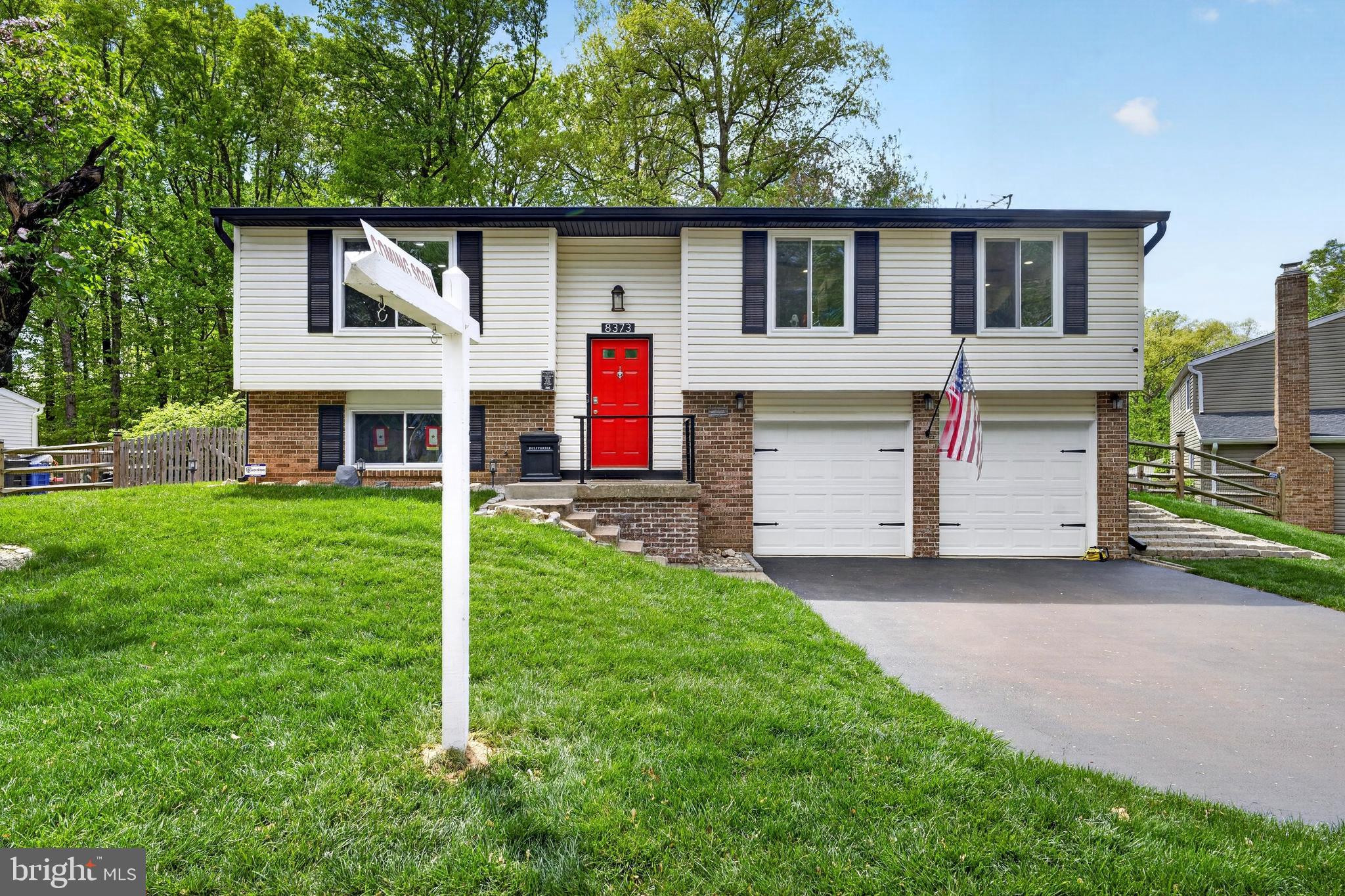 8373 Magic Leaf Road Springfield, VA 22153 - Photo 4 of 69 a front view of a house with a yard and garage