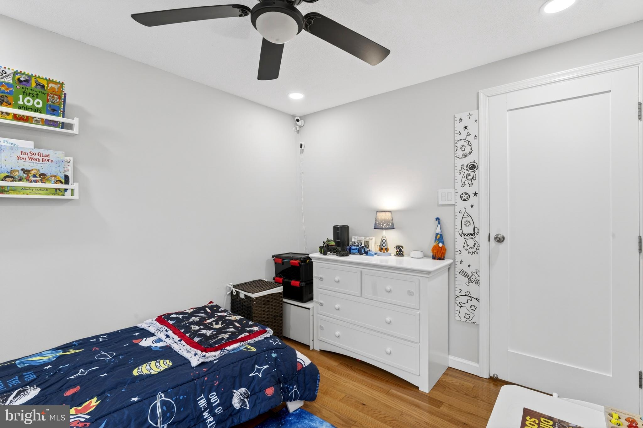8373 Magic Leaf Road Springfield, VA 22153 - Photo 46 of 69 a bedroom with a bed and wooden floor