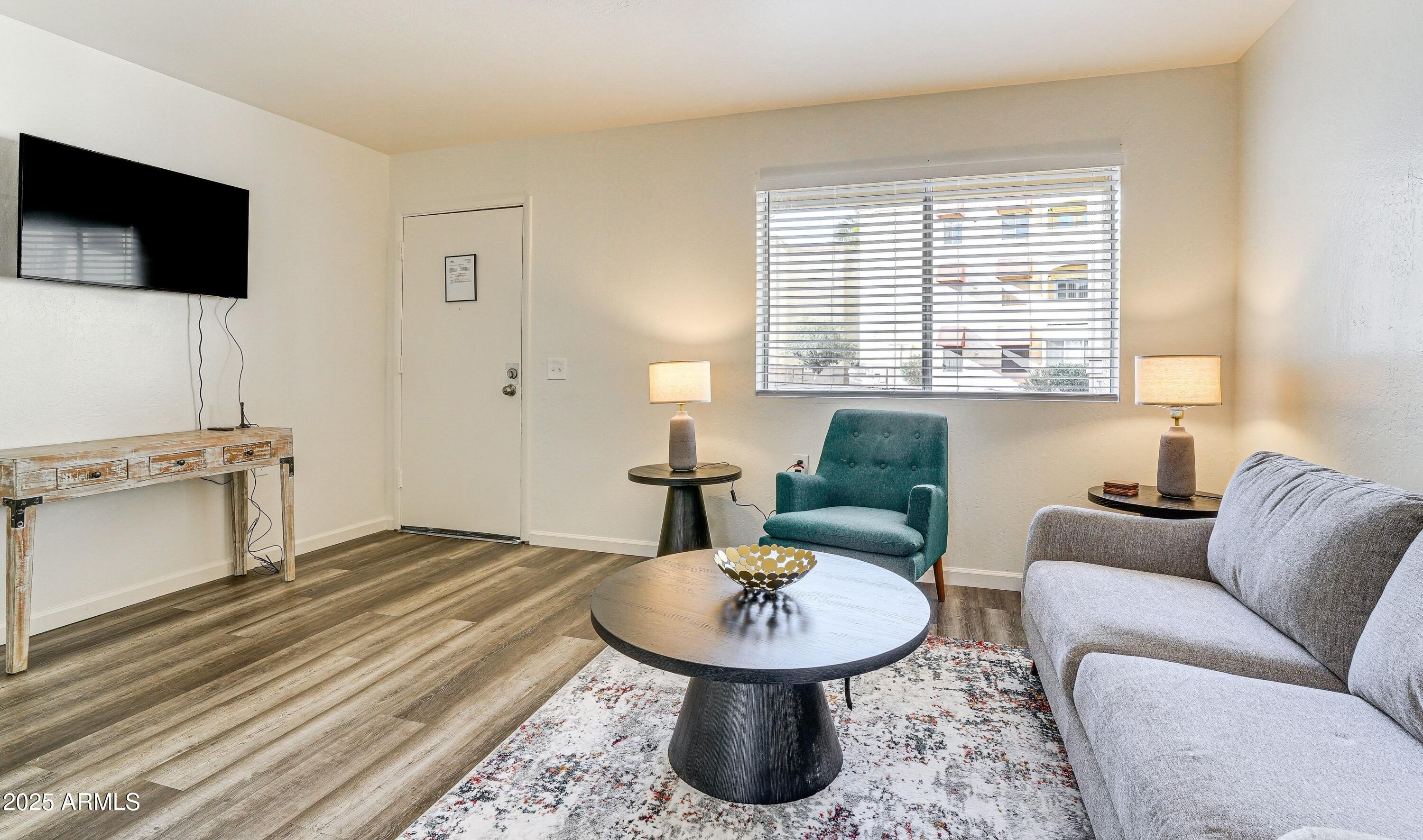 a living room with furniture and a flat screen tv