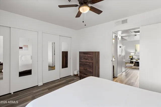 a bedroom with a bed and painting on the wall