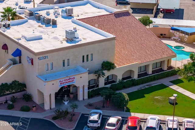 a view of a patio with table and chairs potted plants and palm tree