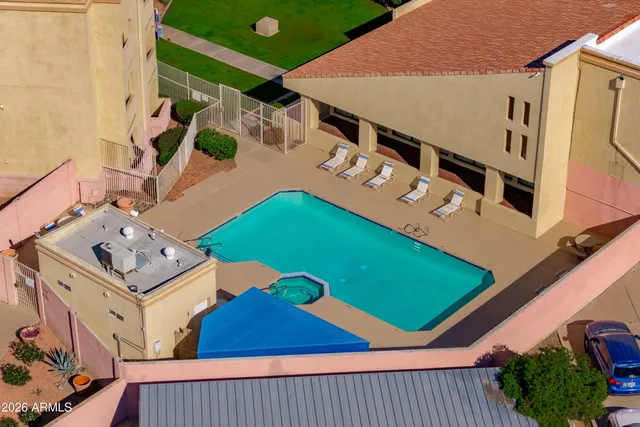 an aerial view of a houses with a swimming pool