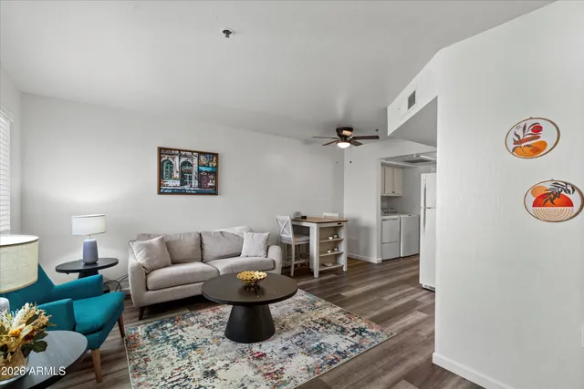 a living room with furniture and a wooden floor
