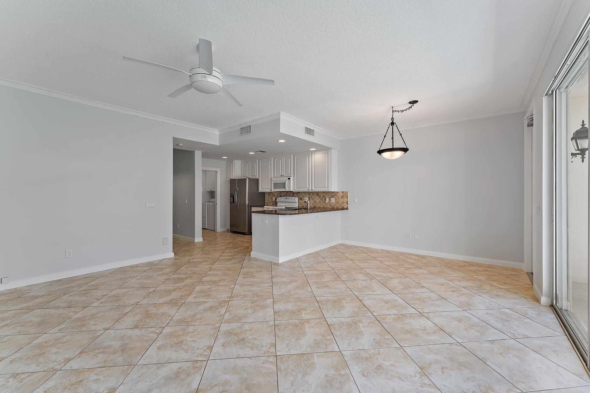 148 Middlebury Drive Jupiter, FL 33458 - Photo 15 of 32 a view of a kitchen with a sink and a refrigerator