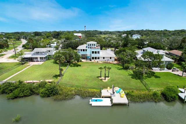 an aerial view of a house with a yard basket ball court and outdoor seating