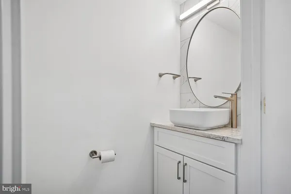 a bathroom with a toilet and a mirror