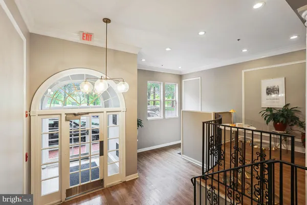 a living room with furniture chandelier and a table