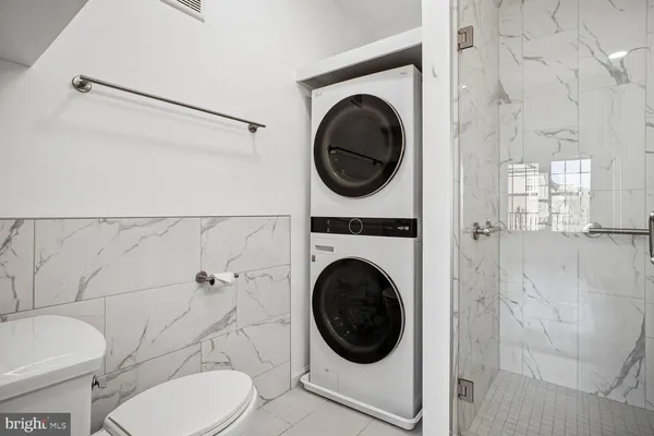 a view of a livingroom with wooden floor and a large window