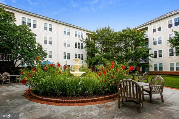 a front view of a house with a yard and fountain