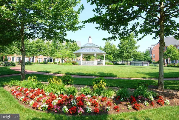 a view of a garden with a building in the background