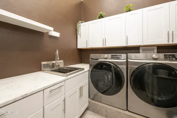 a large kitchen with a table and chairs