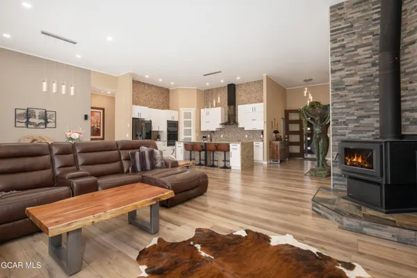 a bedroom with a bed and large windows