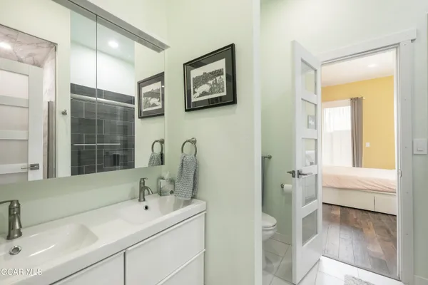 a bedroom with a bed and glass window