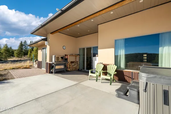 a view of front door with couch and a ceiling fan