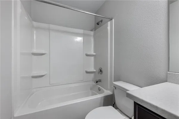 a bathroom with a bathtub and a toilet