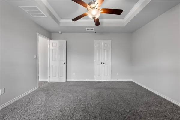 an empty room with a ceiling fan and fan