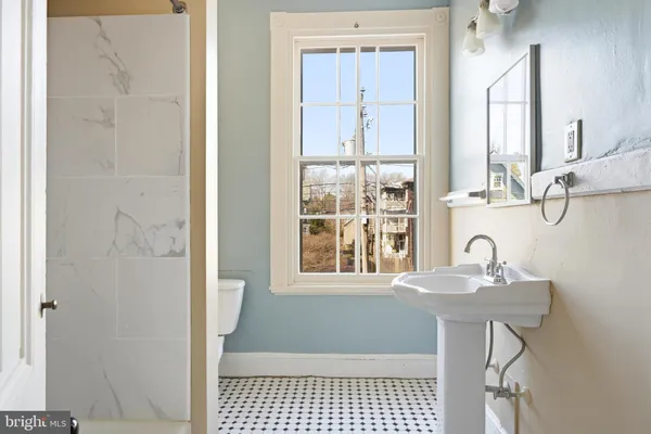 a bathroom with a sink a mirror and a shower