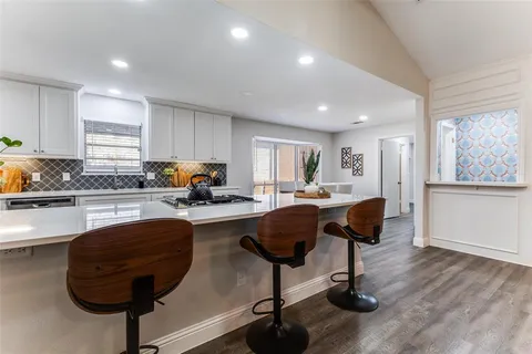 a living room with furniture and kitchen view