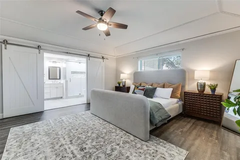 a spacious bedroom with a bed and a chandelier